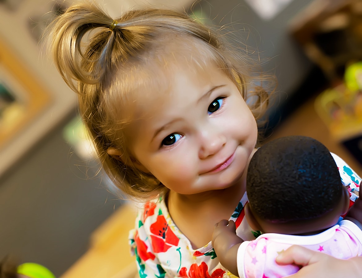 Young child holding a doll