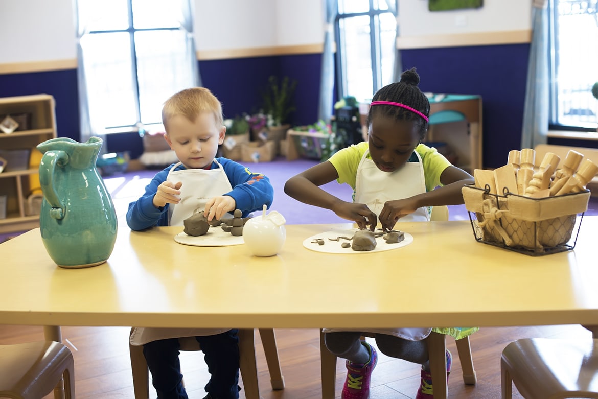 Toddlers sculpting with clay