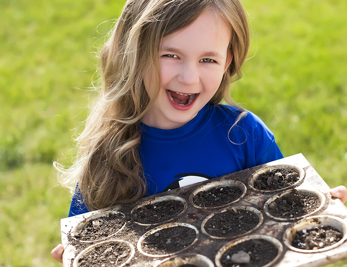 Child Planting Outdoors
