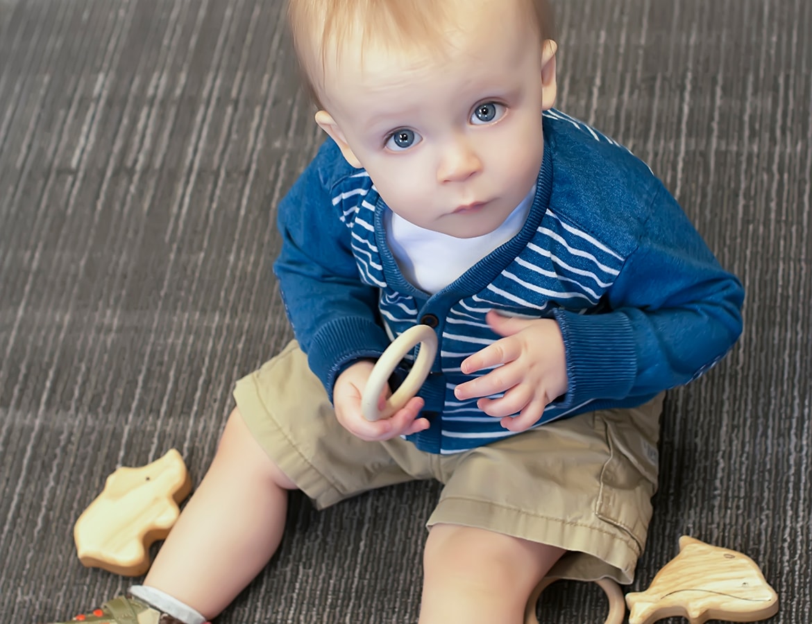 Child Playing with Wooden Toys