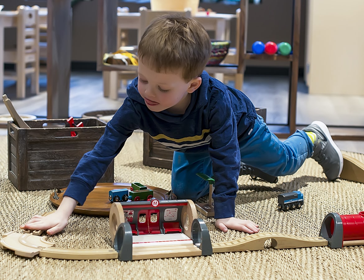 Young Child Playing with Trains
